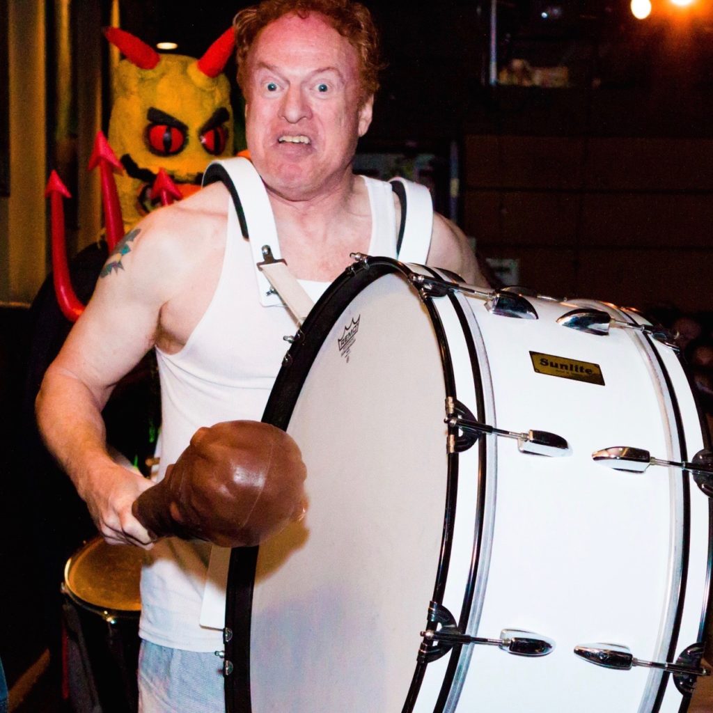 Elfman banging drum